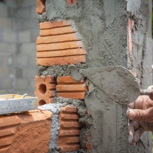 bricklaying-construction-worker-building-brick-wall